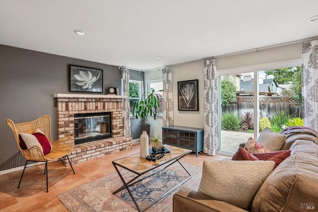 tiled living room with a brick fireplace and baseboards