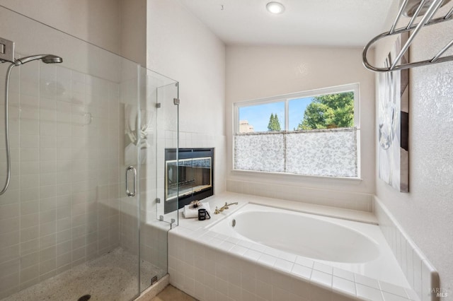 bathroom featuring a stall shower and a garden tub