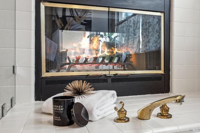 interior details featuring a glass covered fireplace