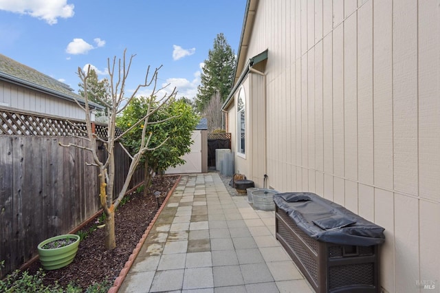 view of patio featuring an outdoor structure and a fenced backyard