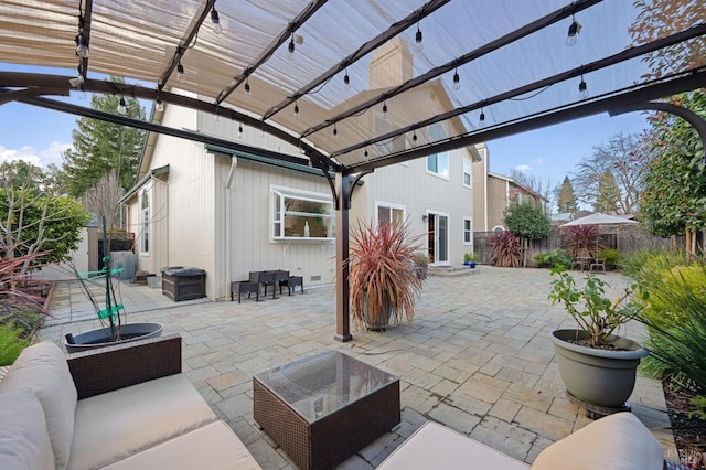 view of patio featuring fence, a pergola, and an outdoor hangout area