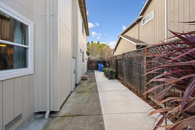 view of side of property with a patio and a fenced backyard