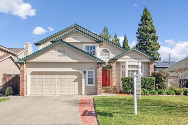 view of front of property with brick siding, a front lawn, fence, a garage, and driveway