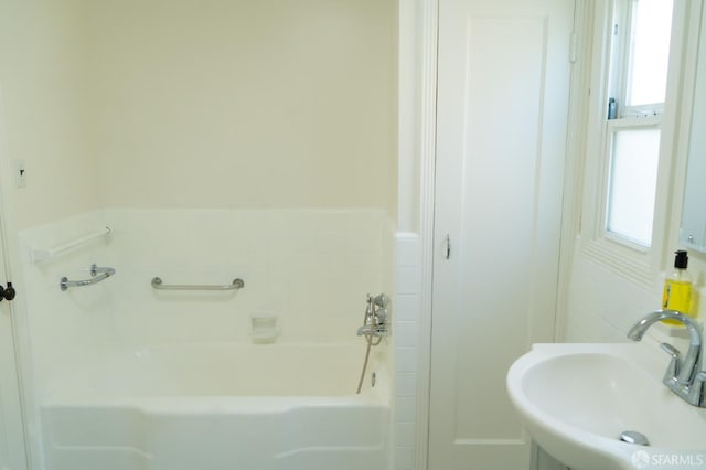 full bathroom featuring a bath and a sink