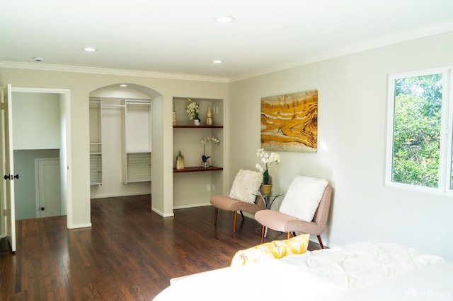 bedroom featuring arched walkways, recessed lighting, a closet, ornamental molding, and wood finished floors