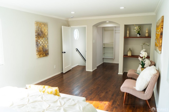 bedroom featuring crown molding, baseboards, and wood finished floors