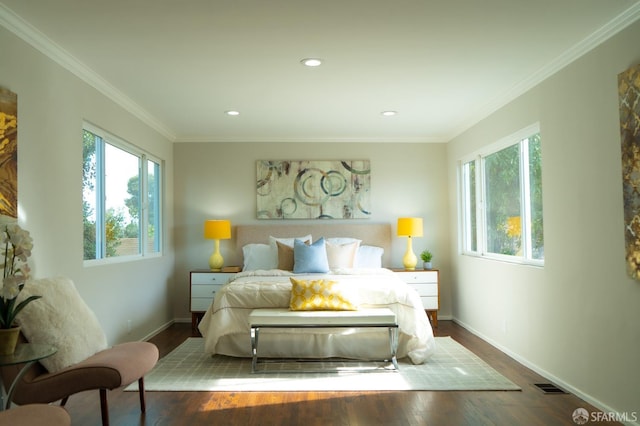 bedroom featuring baseboards, visible vents, dark wood finished floors, ornamental molding, and recessed lighting