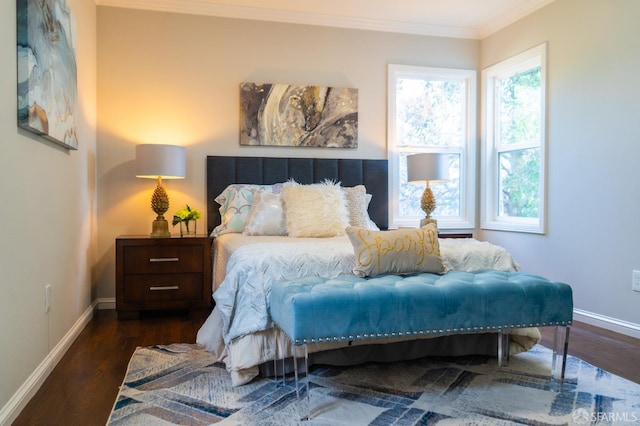 bedroom featuring multiple windows, crown molding, baseboards, and wood finished floors