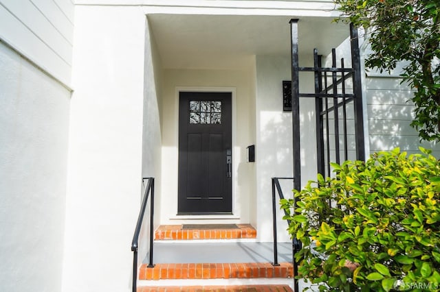 entrance to property featuring stucco siding