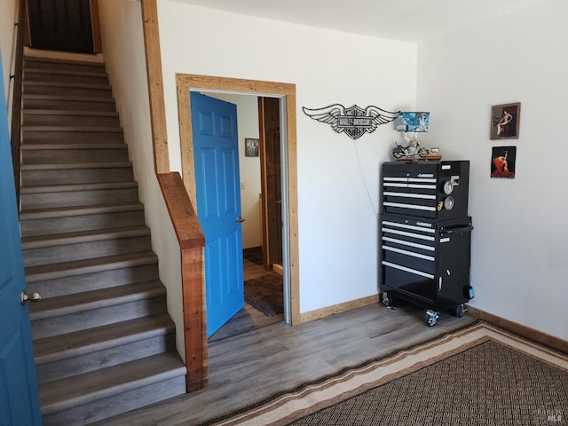 stairs featuring baseboards and wood finished floors