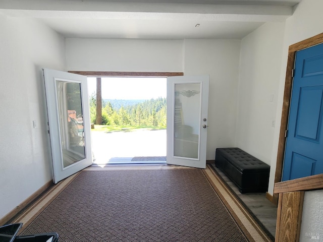 doorway to outside with baseboards