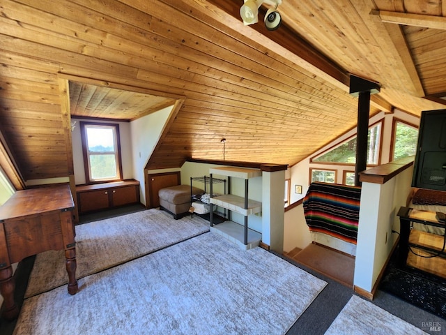 unfurnished bedroom featuring vaulted ceiling with beams, wooden ceiling, baseboards, and dark carpet