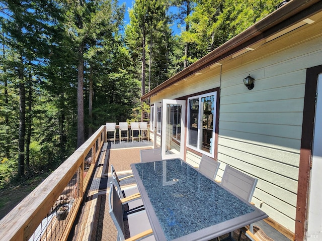 wooden terrace with outdoor dining area