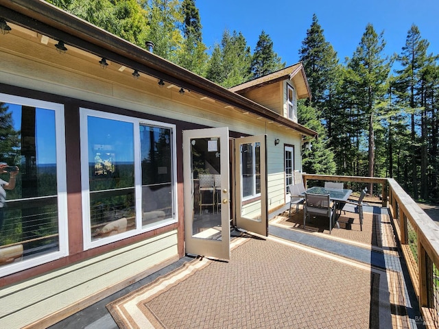 wooden terrace featuring outdoor dining area