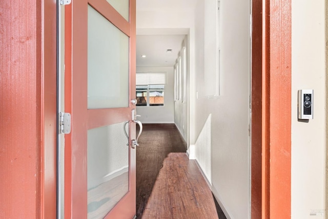 hallway with dark hardwood / wood-style floors