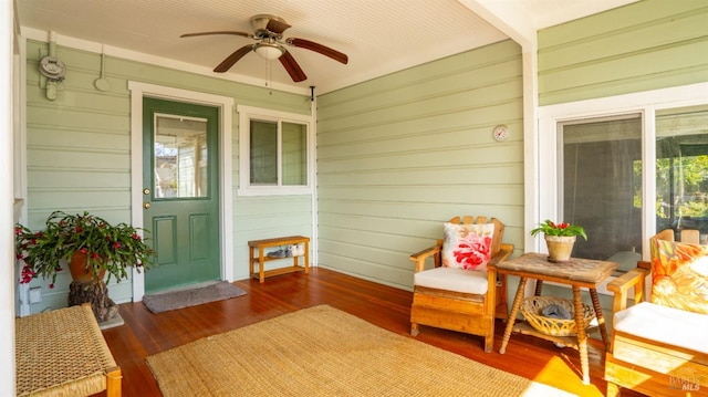 exterior space with ceiling fan and a porch