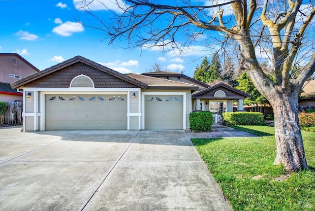 ranch-style house featuring a garage and a front lawn