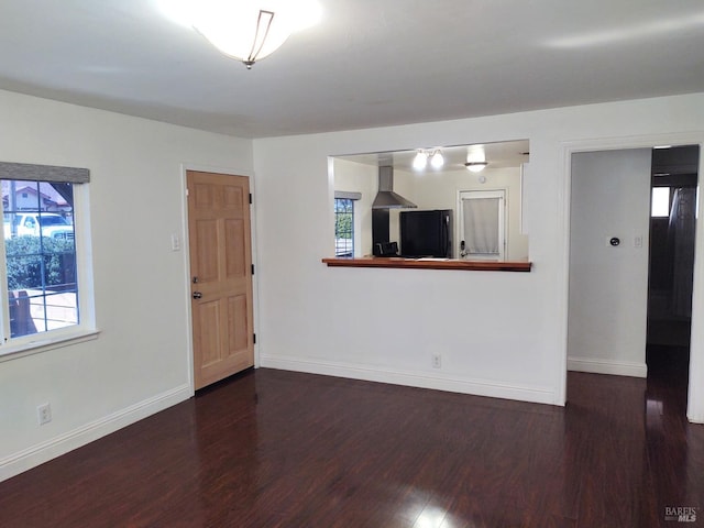 unfurnished room with wood finished floors and baseboards