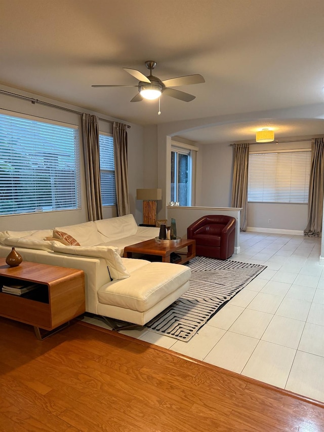 living area with light wood-style floors and ceiling fan