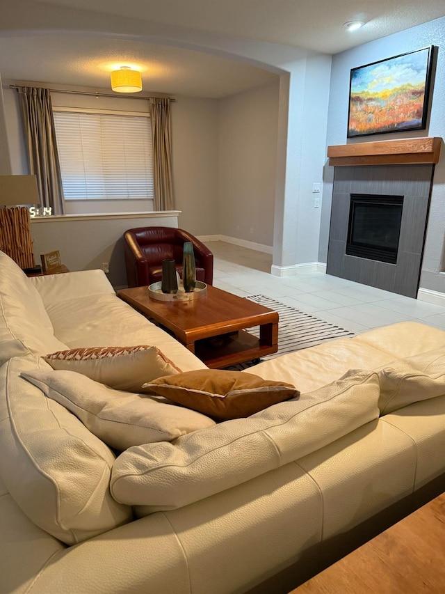 living room featuring a fireplace and baseboards