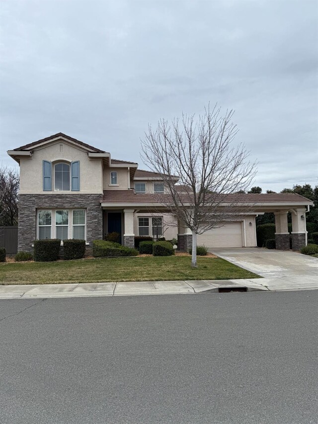 view of front of property with a garage and a front yard