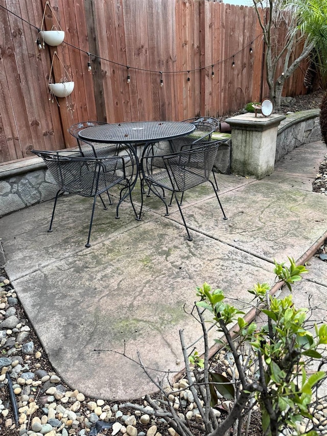 view of patio / terrace featuring outdoor dining space and fence