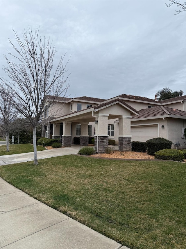 view of front facade featuring a garage and a front yard