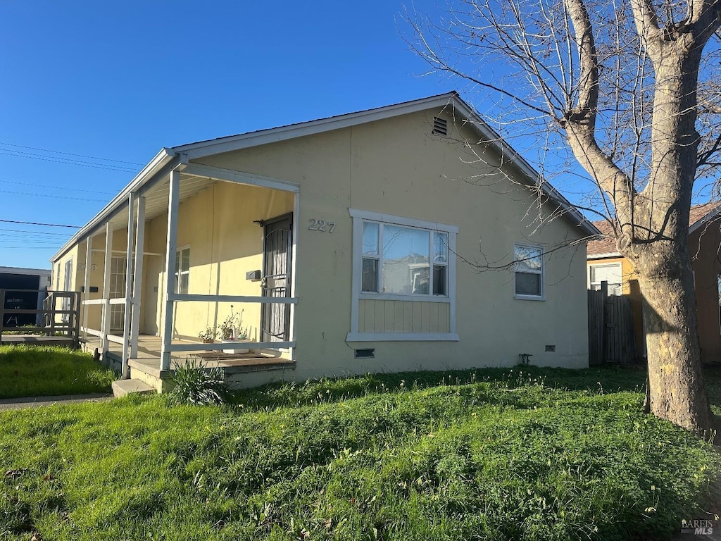 view of property exterior with a lawn