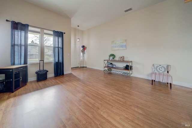 unfurnished room featuring visible vents, baseboards, and wood finished floors
