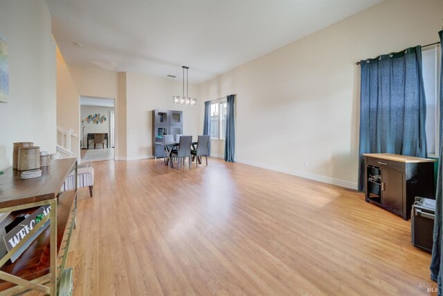 living room featuring light wood finished floors and baseboards
