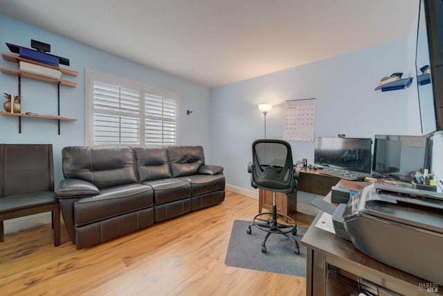 office featuring light wood-type flooring and baseboards