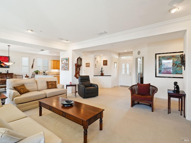 carpeted living room with ornamental molding