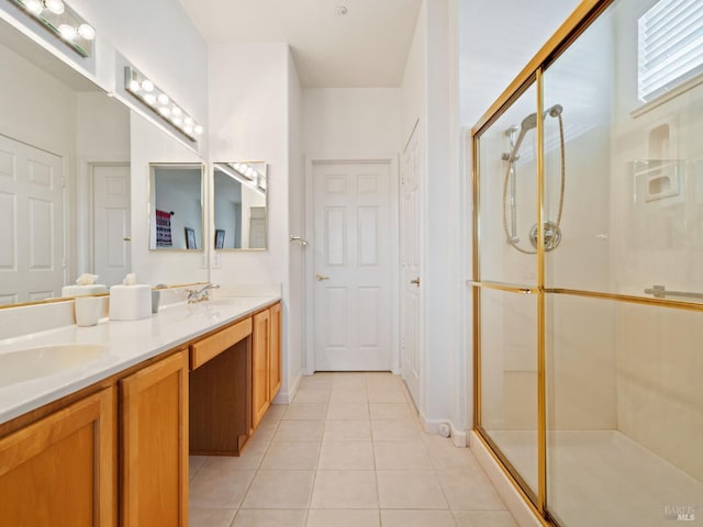 bathroom featuring tile patterned flooring, vanity, and a shower with door