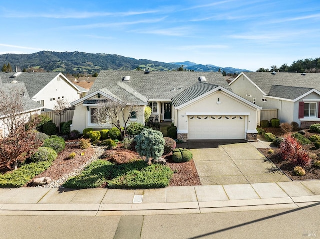 view of front facade featuring a garage and a mountain view