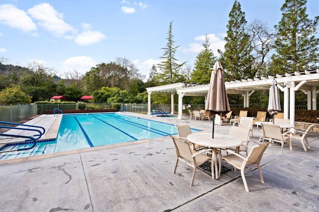 view of swimming pool featuring a patio area and a pergola