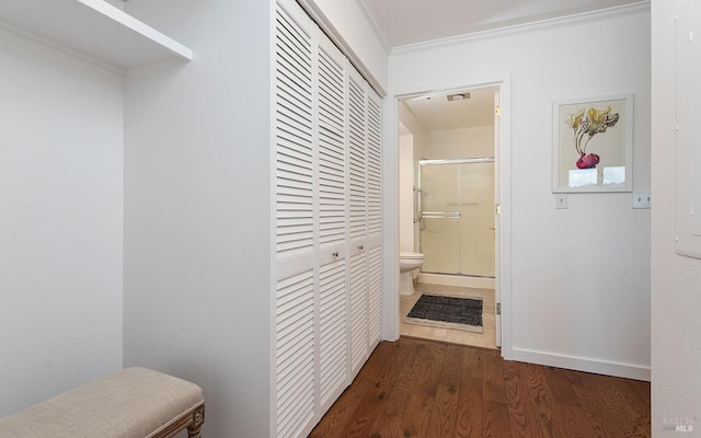 hallway with crown molding and dark hardwood / wood-style floors