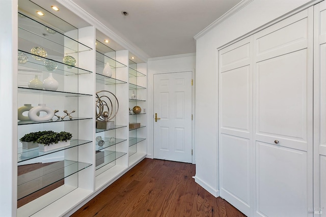 corridor with dark wood-type flooring and ornamental molding