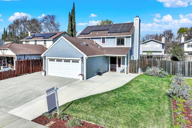 view of front of house with a garage and solar panels