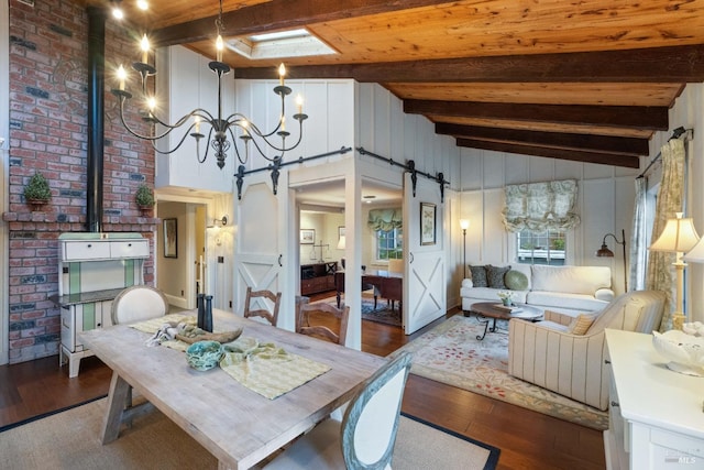 dining area featuring wood-type flooring, a barn door, and lofted ceiling with skylight