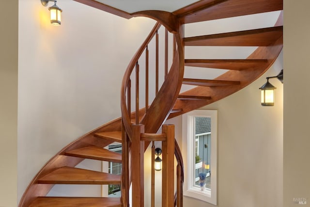 staircase with beamed ceiling