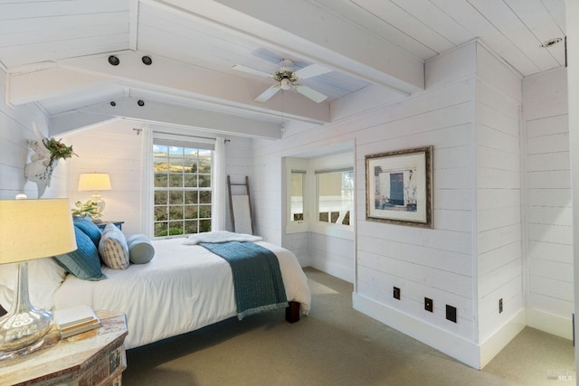 bedroom with wooden walls, lofted ceiling with beams, and carpet