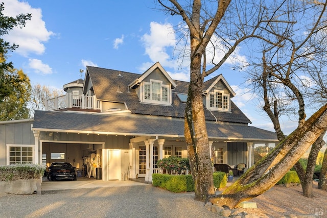 view of front of house with french doors, a balcony, and a garage