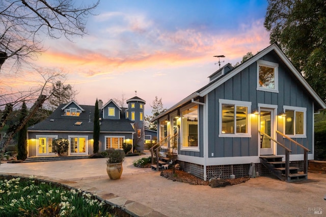 back house at dusk with a patio area