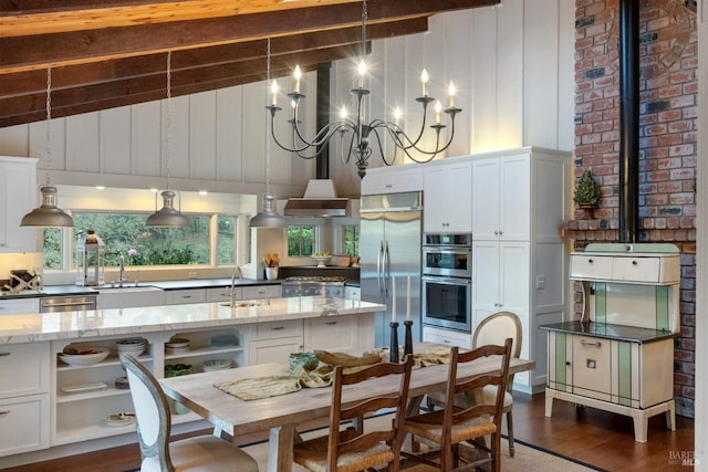 kitchen featuring white cabinetry, high vaulted ceiling, light stone countertops, and appliances with stainless steel finishes