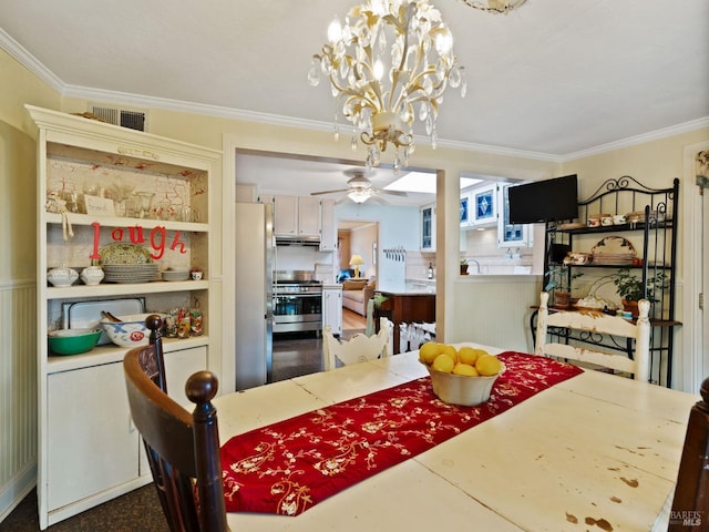 dining area featuring ceiling fan with notable chandelier and ornamental molding