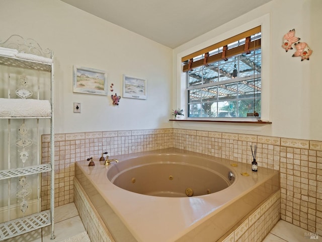 bathroom with tiled tub, tile walls, and tile patterned floors