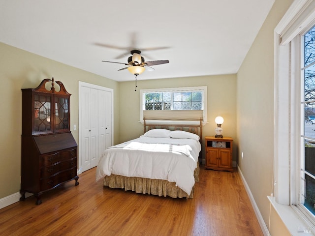 bedroom with hardwood / wood-style flooring, ceiling fan, and a closet