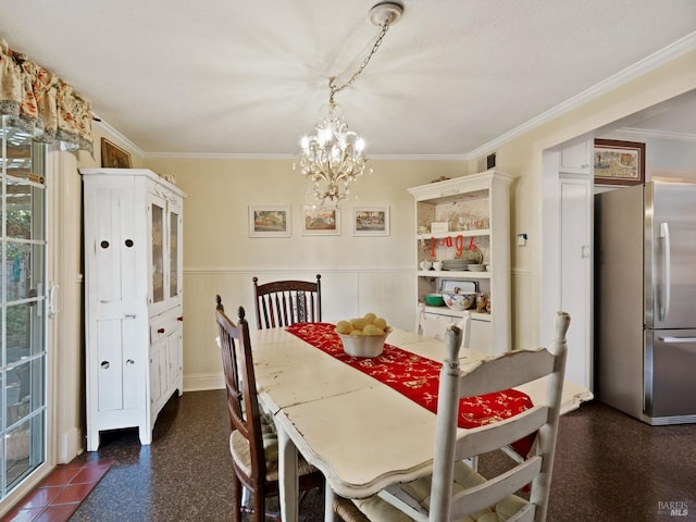 dining space with crown molding and a chandelier