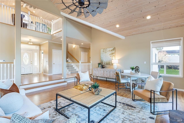 living room with high vaulted ceiling, wooden ceiling, stairway, and wood finished floors