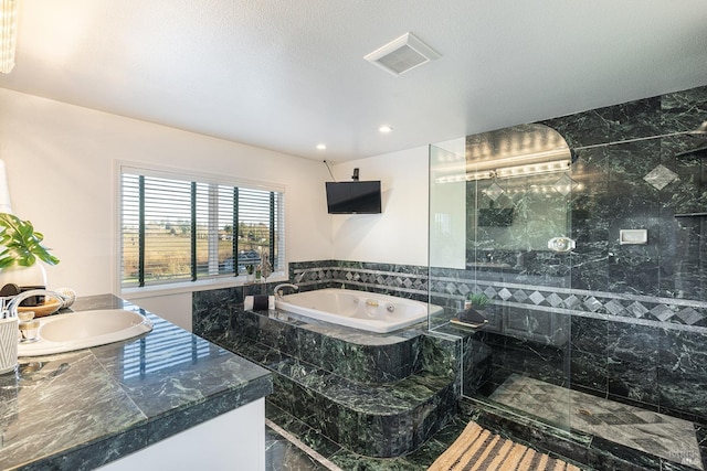 bathroom featuring a garden tub, visible vents, a shower stall, vanity, and a textured ceiling